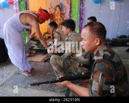 a-priest-blessing-weapons-belonging-to-tsr-2nd-battalion-tripura-state-rifles-during-the-vishw...jpg